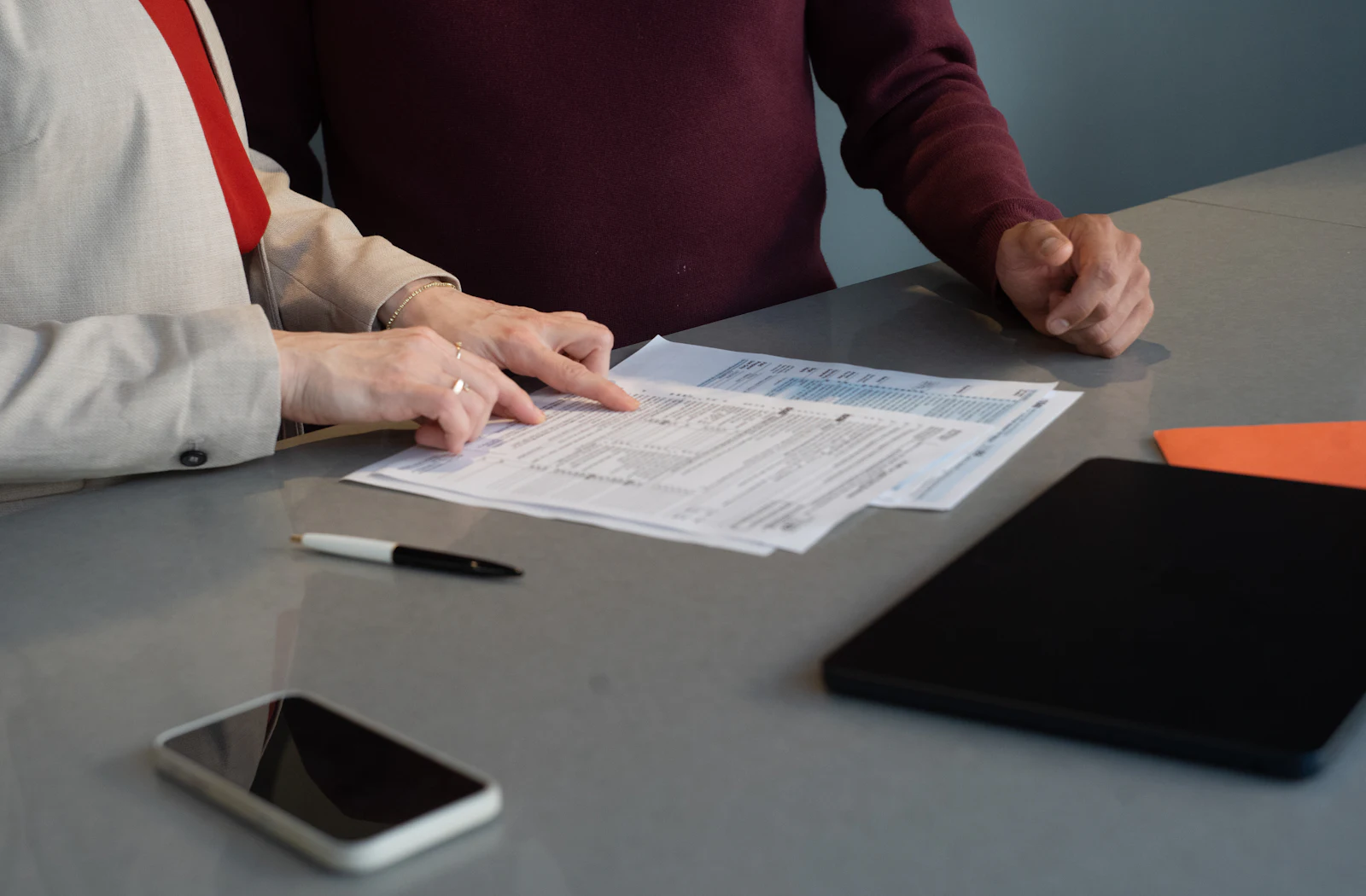 Two people reviewing documents during a consultation